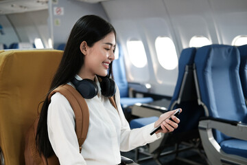 Backpacker asian woman in the airplane while to destination. Travel concept