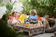 © DragonImages - Group of friends having snacks and chatting when hanging out together