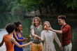 © Halfpoint - Happy group of friends lighting sparklers and enjoying freedom at beach during sunset