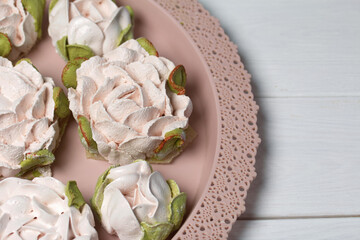 Marshmallow flowers on trays. Homemade zephyr. Close-up.