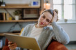 © Halfpoint - Young woman with digital tablet resting in her apartment.