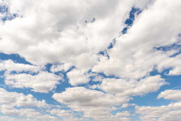 Wall Mural - Natural beautiful abstract scenic azure blue sky with white cumulus clouds background on bright sunny summer day. Nature cloudscape tranquil landscape scene backdrop pattern