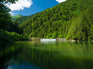 Canvas Print - Waterfall flowing into the still lake in spring time. Uzungol waterfall. Trabzon, Turkey 