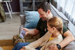 Side view portrait of father and daughter talking by video chat with family, copy space