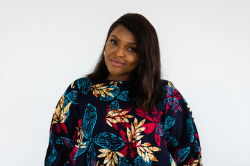 Poster - Young african american woman wearing dress posing over white wall at home - inclusion and diversity concept