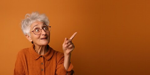 Wall Mural - Portrait of an Older Lady Looking Up and Pointing to Copy Space (Generative AI)