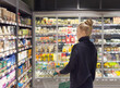 © lado2016 - supermarket shopping,Woman choosing a dairy products at supermarket.