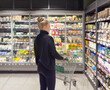 © lado2016 - supermarket shopping,Woman choosing a dairy products at supermarket.