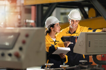 Wall Mural - factory engineering manager teaching female mechanic trainee for job training and apprentice. young apprentices in technical vocational training are taught by older trainers on a cnc lathes machine