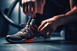 © Nilima - a minimalist urban gym, a dedicated fitness enthusiast meticulously knots his sports shoes, ready to conquer a challenging workout amidst the sleek, modern equipment