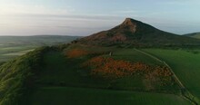 Drone Footage Of Roseberry Topping And Aireyholme Farm, North Yorkshire England. The Childhood Home Of Captain James Cook. The Gorse In Full Bloom Beneath Roseberry Topping.