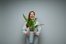 Happy Excited Woman Holding Home Plant In Pot And Looking Up.