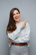 © Yuriy Shevtsov - Smiling woman pointing finger at side to copy space. Isolated portrait female business person.