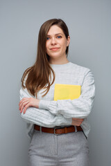 Wall Mural - Young accountant woman holding yellow book. Isolated portrait.