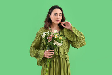 Sticker - Young woman in dress with alstroemeria flowers on green background