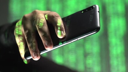 Vertical closeup of green code text rolling over smartphone in hand