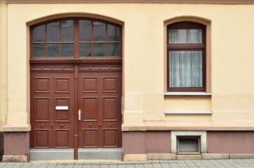 Wall Mural - View of old building with wooden door and window