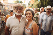 © TRINETTE + CHRIS - Portrait of Hispanic senior couple at large family gathering outdoors in backyard in summer. Generative AI.