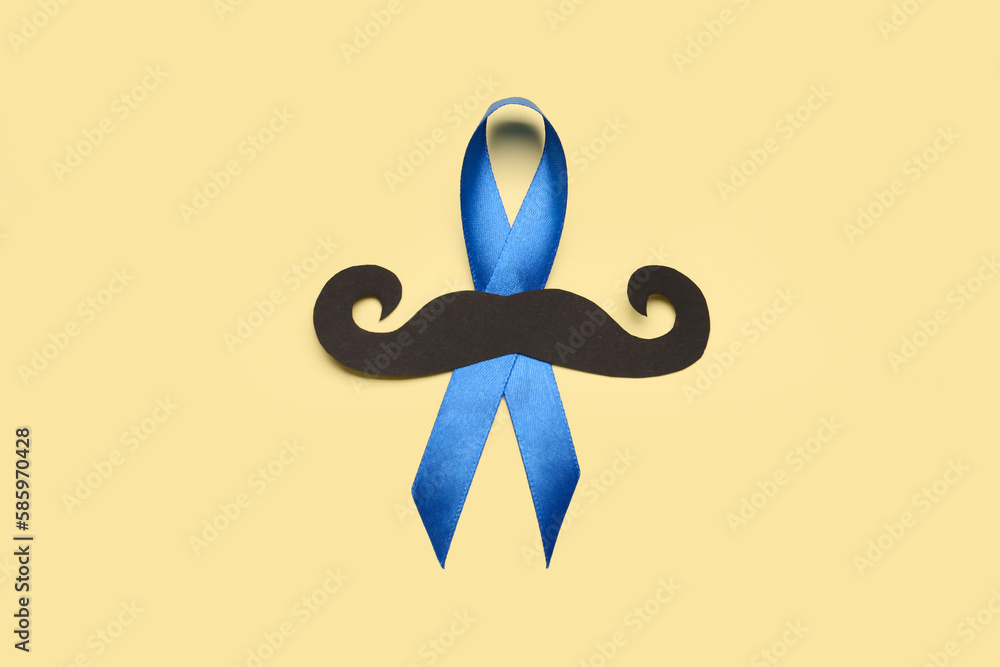 Blue awareness ribbon with black paper mustache on color background