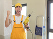 © kues1 - young handsome man feeling shocked,laughing and celebrating success. handyman concept