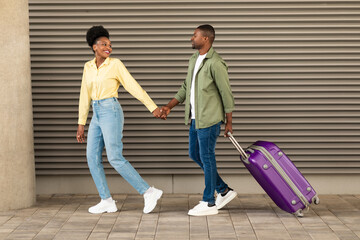 Wall Mural - Full Length Shot Of Black Spouses Walking With Suitcase Outside