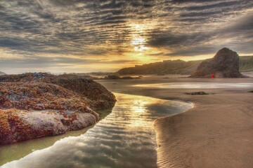 Sticker - Beautiful scene of the desert with rocks covered by moss and a small spring at sunset