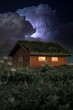 Vertical shot of a stormy purple thunder sky over a wooden cabin
