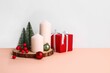 Christmas setup with colorful decorations against white wall with copyspace