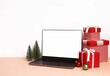 Christmas setup with decorations and blank notebook screen in the middle for mockup