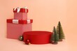 Christmas setup with colorful decorations and red podium for product display