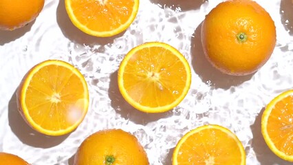 Sticker - Top view of the cut and whole fresh orange in the water on a white background