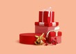 Studio shot of red gift boxes, berries and golden bells for a background usage