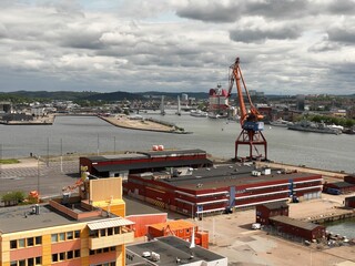 Drone view of containers crane in a port with cityscape in the background