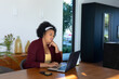 © WavebreakMediaMicro - Plus size african american woman sitting at table, using laptop