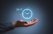 © RerF - Best service mind concept. Businessman hand holding virtual analog clock with word 24/7 for worldwide nonstop and full-time available contact of service concept. Ready customer service support team.