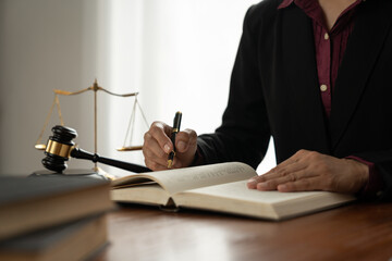 female lawyer, law adviser, businesswoman sitting and reading with finger pointing at legal code inf