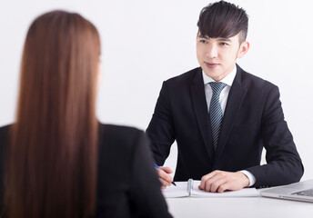 Wall Mural - Business manager interviewing young women job applicant in the office