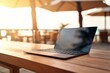 © Thares2020 - Beach Laptop. Business and Technology on Outdoor Table with Blurred Background