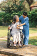 © NanSan - Young asian care helper with asia elderly woman on wheelchair relax together park outdoors to help and encourage and rest your mind with green nature.