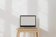 Laptop Computer With Blank Screen And Sunlight Shadows On The Wall. Minimal Styled Website, Online Shop, Store, Social Media Template With Mockup Copy Space