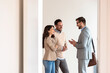 © lordn - Young married couple talking with a real-estate agent visiting an apartment for sale or for rent. Future parents buying an apartment. Real estate concept. A new beginning