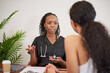 © Meeko Media - Candid shot of Black female doctor explaining to patient during GP consultation