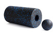 Massage set: A black blue foam roller and mfr massage ball isolated on a white background. Close-up. Foam rolling is a self myofascial release technique. Concept of fitness equipment.