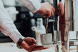 The waiter preparing coffee for hotel guests. Close up photo of service in modern hotels