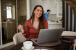 © Studio Dva Kera - Pretty young businesswoman having a video call while working from home.