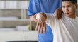 © ArLawKa - Young Asian man doing physiotherapy and seeking advice from muscle pain with shoulder, limbs in rehabilitation center.