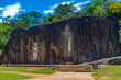 Buddha statues carved into stone at buduruwagala ancient site at Sri Lanka