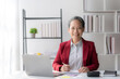 © amnaj - Asian senior female executive with laptop computer working in office.