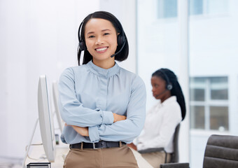 Canvas Print - Asian woman, call center and arms crossed in portrait, communication and CRM, headset with mic in office. Contact us, customer service or telemarketing, female consultant with smile and help desk