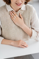Wall Mural - cropped view of sign language teacher showing please word during online lesson on laptop.